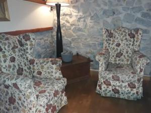 a living room with two chairs and a lamp at Kuko Hotel - Adults Only in Oronoz-Mugaire