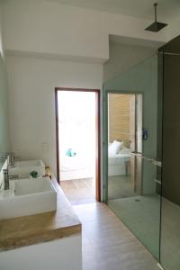 a bathroom with a shower, sink, and tub at Hotel La Casa Cielo in El Cuyo
