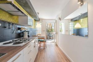 a kitchen with white cabinets and a stove top oven at Luxury 1 Bedroom Apartment in Rabac in Rabac