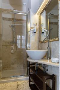 a bathroom with a sink and a shower at Relais Dei Mercanti B&B And Suites in Pisa