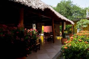 a pavilion with chairs and flowers in a garden at Hostal Cultural El Telar in San Jacinto