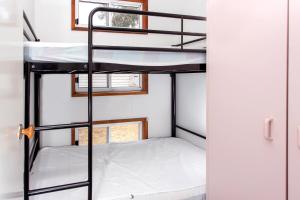 two bunk beds in a room with a window at Ingenia Holidays Torquay Australia in Torquay