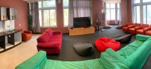 a living room with couches and a flat screen tv at 790 on George Backpackers in Sydney +39 photos