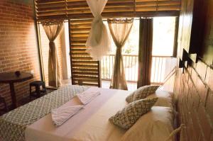 a bedroom with a bed and a large window at I Wanna Palomino in Palomino