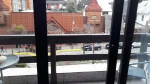 a view from a window of a street with a church at apto centro de gramado in Gramado +2 photos