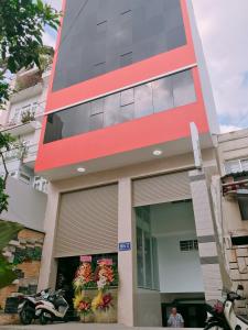 a tall building with a red stripe on it at Hotel thanh vinh in Ho Chi Minh City