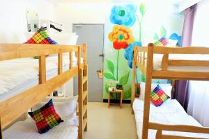 a dorm room with two bunk beds and a mural at Kamusta Boutique Hotel in Boracay