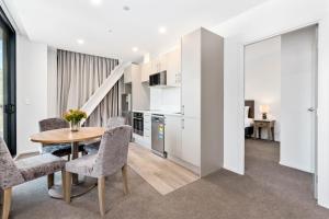 a kitchen and dining room with a table and chairs at Kawarau View in Queenstown