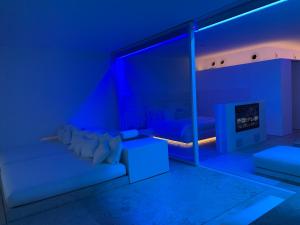 a blue room with a couch and a fireplace at Oceanview Apartment in San José del Cabo