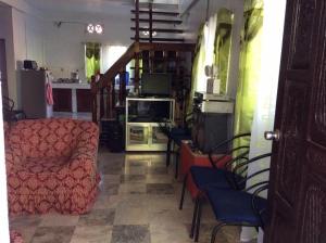 a living room with a couch and a tv at Troy Lodge in Basco