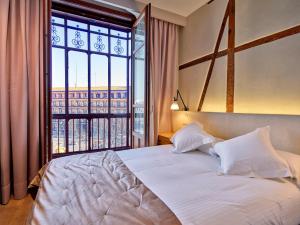 Postel nebo postele na pokoji v ubytování Hotel Boutique ADOLFO