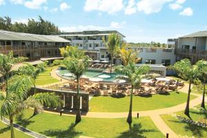 an aerial view of a resort with a pool and palm trees at Be Cosy Apart Hotel in Trou aux Biches