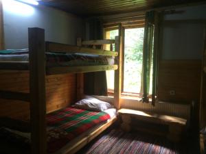 a room with two bunk beds and a window at Malka Yurta Hut in Panichishte
