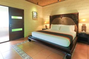 Postel nebo postele na pokoji v ubytování Munari Resort Ubud