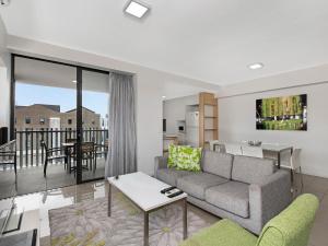 a living room with a couch and a table at Atrio Apartments in Brisbane