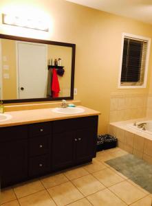 a bathroom with a sink and a large mirror at Sweet dreams in Guelph +26 photos