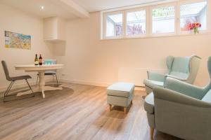 a living room with a table and two chairs and a table and a couch at Clean and modern nassau canal apartment in Amsterdam