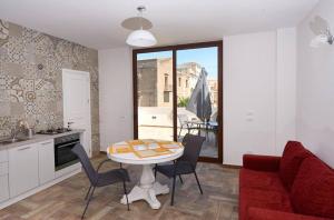 a kitchen and living room with a table and chairs at Veranda sul Mare in Castellammare del Golfo +11 photos