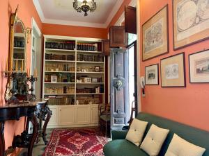 a living room with a green couch and a book shelf at Villino Eleonora in Parghelia