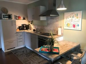 a kitchen with a sink and a table with a plant on it at Ferienwohnung Laurent in Pünderich