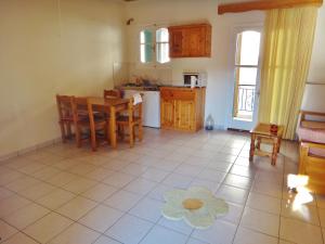 a kitchen and dining room with a table and chairs at Lefkothea Apartments in Lefkada