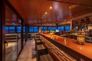 a bar with a long wooden counter in a room at Attalos Hotel in Athens