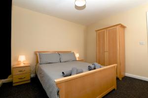 a bedroom with a bed with blue towels on it at Library Square Penthouse in Belfast