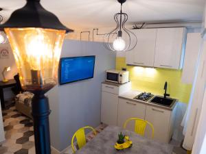 Appartamenti Vale Mare في كيودجا: مطبخ صغير مع طاولة وميكروويف