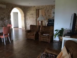 a living room with two chairs and a table at Casa da Trapa in Oliveira de Azemeis