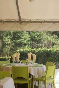 a table with wine glasses and chairs under a tent at MOULIN DE LACHAUD - HOTEL et GITES in Sainte-Fortunade