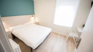 Posteľ alebo postele v izbe v ubytovaní Happy Hostal Carrales