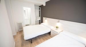 Postel nebo postele na pokoji v ubytování Happy Hostal Carrales