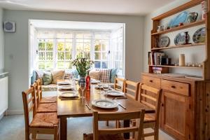 a dining room with a wooden table and chairs at 7 Whinlands in Thorpeness