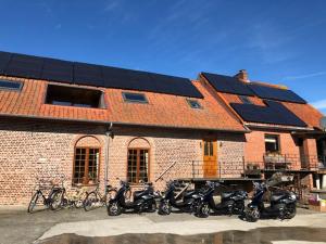 
motorcycles parked in front of a brick building at Apartment 't Hennekot Palingbeek in Ypres
