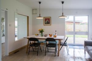 a kitchen and dining room with a table and chairs at Invershin in Thorpeness