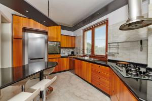 a kitchen with wooden cabinets and a black counter top at Villa Anna in Brenzone sul Garda