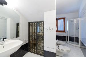a white bathroom with a sink and a toilet at Villa Anna in Brenzone sul Garda +32 photos