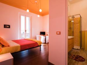 a bedroom with a bed and a shower and a tub at B&B VILLA TOZZA in Senigallia