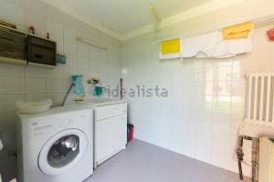 a laundry room with a washing machine in it at Villa Anna in Brenzone sul Garda