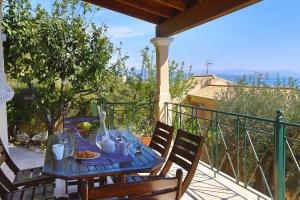 a blue table with food on a balcony at Villa Dimeli in Barbati