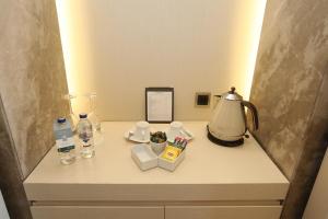 a table with a lamp and other items on it at Kemer Country Hotel İstanbul in Istanbul