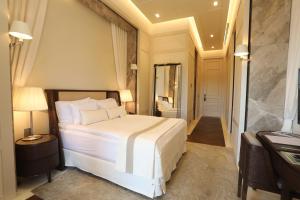 a bedroom with a white bed and a hallway at Kemer Country Hotel İstanbul in Istanbul
