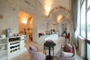 a large kitchen with white cabinets and a table and chairs at Hotel Ristorante Vittoria in Pompei