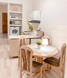 a kitchen with a table and chairs in a kitchen at Hostel u Kmity in Krakow +51 photos