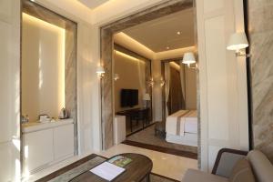a hotel room with a bed and a mirror at Kemer Country Hotel İstanbul in Istanbul