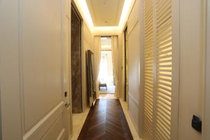 a hallway with wooden floors and white walls at Kemer Country Hotel İstanbul in Istanbul