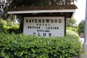 a sign on a post in front of a bush at Ravenswood British Legion in Banchory