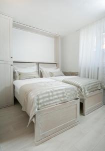 a bedroom with a bed and a dresser at Villa Matejuska Heritage in Split