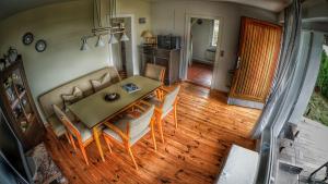 a living room with a dining room table and chairs at Haus am Hügel in Groß Zicker