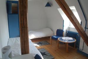 a small room with a bed and a table at Emmaus Hostel in Haslev +57 photos